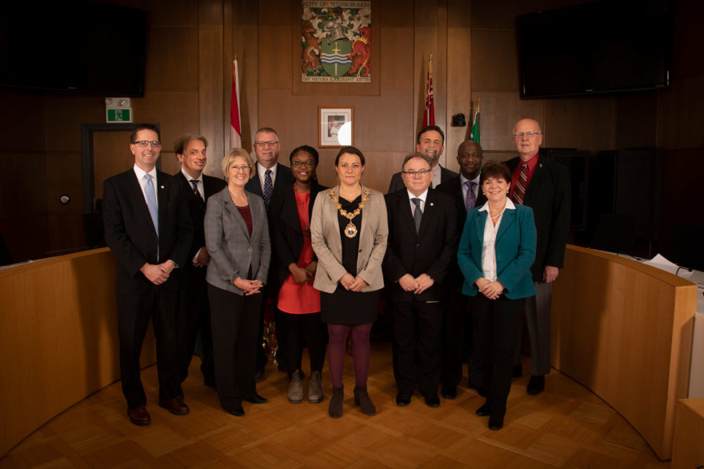 Peterborough City Council members standing in the Council Chambers