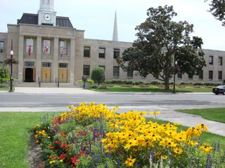 Peterborough City Hall as seen from across George Street with flowers in the foreground