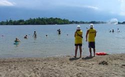 2 lifeguards watching swimmers at Rogers Cove beach on Little Lake