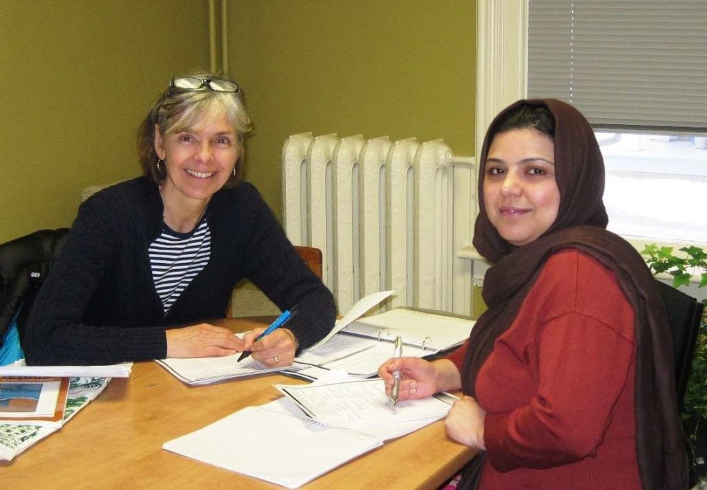 Newcomer to Canada receiving English tutoring from a local volunteer